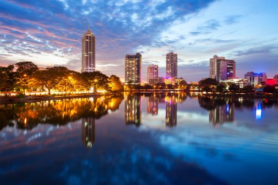 Beira lake and Colombo city skyline view at sunset. Beira lake is a lake in the center of the Colombo in Sri Lanka.
